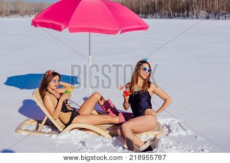 Novokuznetsk, Kemerovo region, Russia - 23 Feb, 2017 : White beaches of Siberia is an enterteiment activity where people playing beach games dressed in bikini in winter. Women in bikini with cocktails