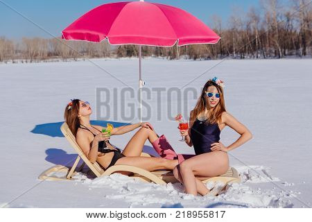 Novokuznetsk, Kemerovo region, Russia - 23 Feb, 2017 : White beaches of Siberia is an enterteiment activity where people playing beach games dressed in bikini in winter. Women in bikini with cocktails