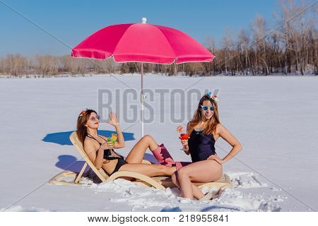 Novokuznetsk, Kemerovo region, Russia - 23 Feb, 2017 : White beaches of Siberia is an enterteiment activity where people playing beach games dressed in bikini in winter. Women in bikini with cocktails