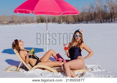 Novokuznetsk, Kemerovo region, Russia - 23 Feb, 2017 : White beaches of Siberia is an enterteiment activity where people playing beach games dressed in bikini in winter. Women in bikini with cocktails