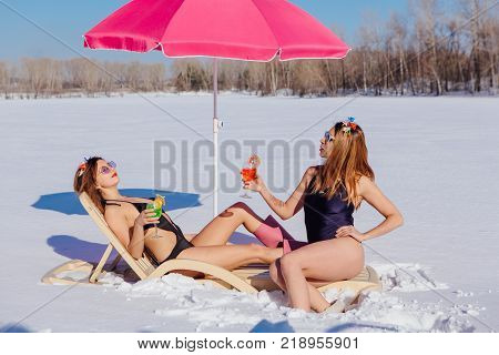 Novokuznetsk, Kemerovo region, Russia - 23 Feb, 2017 : White beaches of Siberia is an enterteiment activity where people playing beach games dressed in bikini in winter. Women in bikini with cocktails