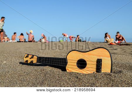 Photo Picture of a Guitar on the Sand Beach