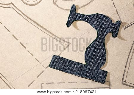 A stencil of a sewing machine of jeans drawing clothing on paper object