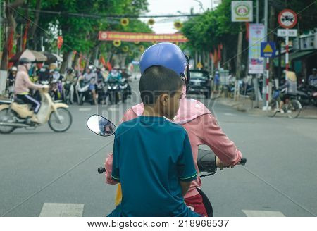 Long Xuyen Vietnam - Sep 1 2017. People riding motorbike on busy street in Long Xuyen Vietnam. Long Xuyen is the provincial city and capital city of An Giang Province.