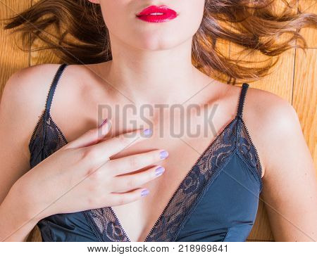 Young woman in negligee underwear on the floor, body detail