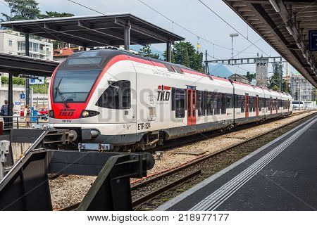 Locarno Switzerland - May 28 2016: A passenger train of the TILO (Regional Train Ticino Lombardia) at a platform of the Locarno railway station.