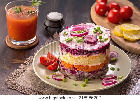 Herring under a fur coat and tomato juice. Russian national cuisine