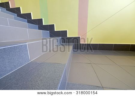 Wide Staicase Covered With Ceramic Tiles Indoors In A House Interior.