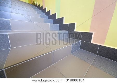 Wide Staicase Covered With Ceramic Tiles Indoors In A House Interior.