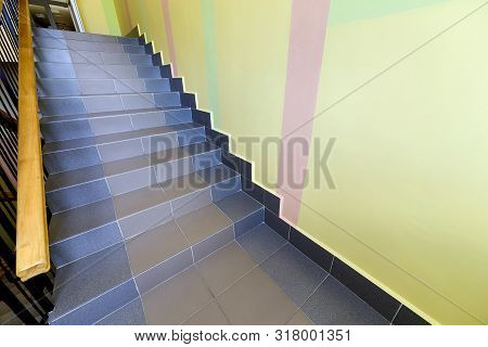 Wide Staicase Covered With Ceramic Tiles Indoors In A House Interior.