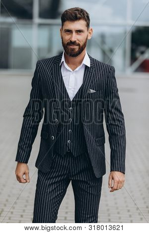 Confident Businessman. Confident Young Man In Full Suit Adjusting His Sleeve And Looking Away While 
