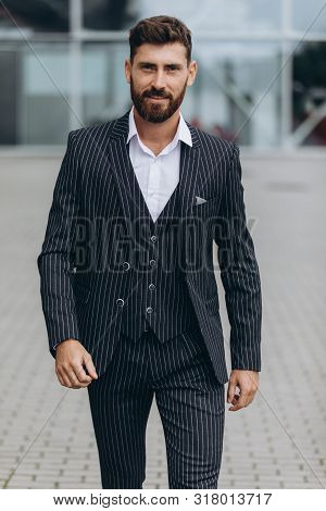Confident Businessman. Confident Young Man In Full Suit Adjusting His Sleeve And Looking Away While 