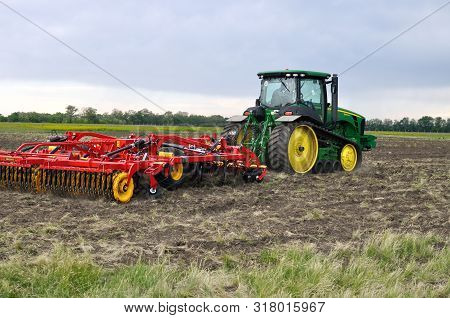Cherkasy, Ukraine - May 18, 2018: Modern John Deere Tractor Model 8345rt Ploughing An Agricultural F