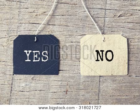 Inspirational Words - Yes And No Written On A Tagged Paper. Blurred Styled Background.