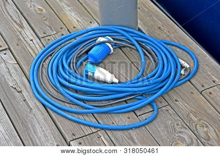 Power Cable Roll With Waterproof Connector On Vintage Wooden Surface, Modern Electric Tools Diversit
