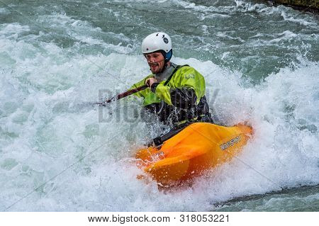 Augsburg, Germany - June 16, 2019: Whitewater Kayaking, Extreme Kayaking. A Guy In A Kayak Sails On 