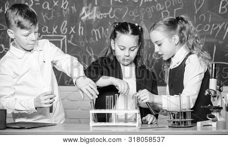 Students Doing Biology Experiments With Microscope In Lab. Little Kids Learning Chemistry. Looking A