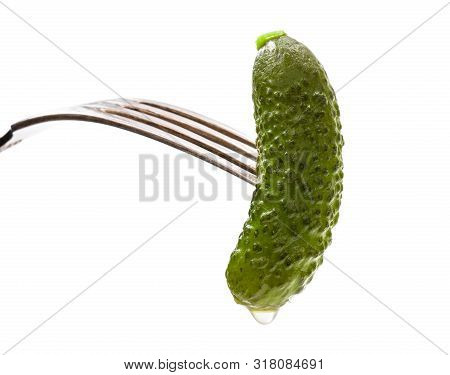 Pickled  Cucumber Sticking On A Fork Isolated On White