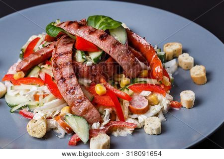 Salad With Grilled Sausage Paprica Cucumber And Croutons