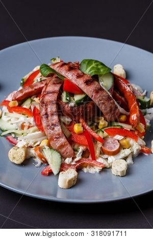 Salad With Grilled Sausage Paprica Cucumber And Croutons