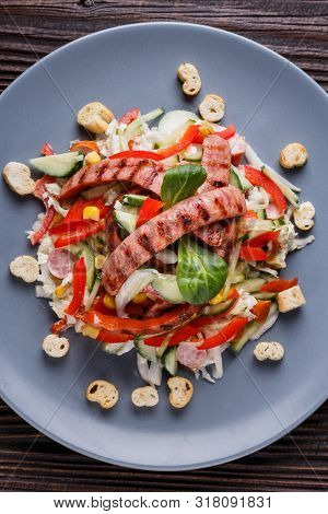 Salad With Grilled Sausage Paprica Cucumber And Croutons