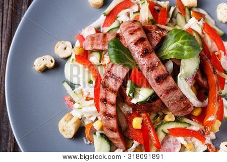 Salad With Grilled Sausage Paprica Cucumber And Croutons