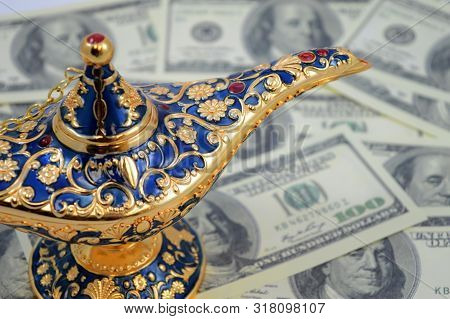 A Magic Genie Lamp Overtop Of An Abundance Of American Money For The Wishful Thinking To Accumulate 