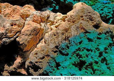 Two Tone Colors Of Rough Stone, Brick Red And Jade Green Colors, Closeup To The Surface, In The Unde