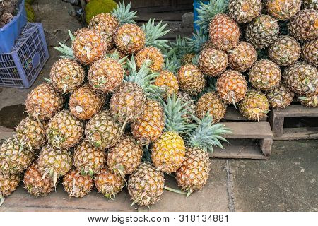 Stack Of Fresh Pineapple For Sale At Outdoor Fruit Market