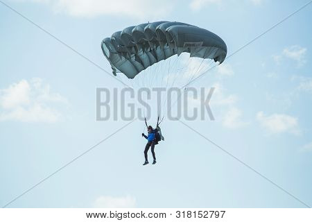 City Riga, Latvian Republic. Avio Show In Honor Of The City Festival. Parachutists Land With Parachu