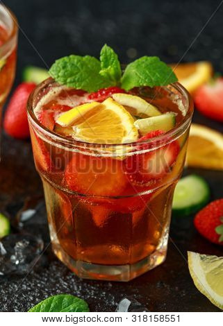Refreshing Pimms Cocktail With Fruit And Vegetables On Rustic Black Table