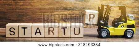 Wooden Blocks With The Word Startup. Temporary Structure Designed To Find And Implement A Scalable B