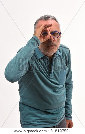 Man Looking Through Fingers As If Wearing Glasses On White Background