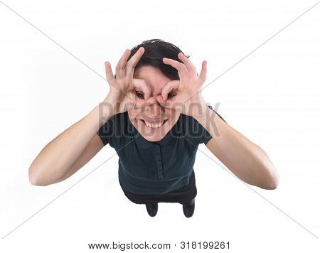 Woman Looking Through Fingers As If Wearing Glasses On White Background