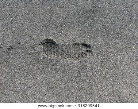 Footprint On Sand Close-up. Summer Concept. Vacation Concept