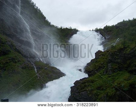 Huge Waterfall In The Mountains In Norway