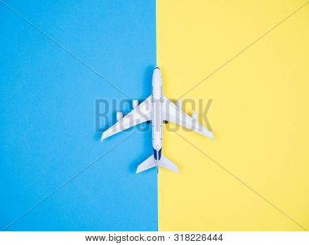 Flat Faly Top View Of Aeroplane Toy Over Blue Background