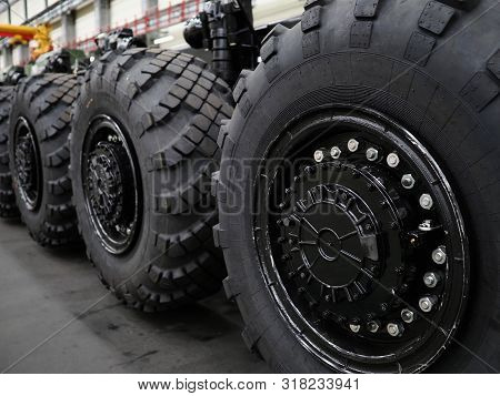 Heavy Wheeled Tires Tractor On Assembly Line Of The Plant For Transport Non-standard Cargo Unusual B