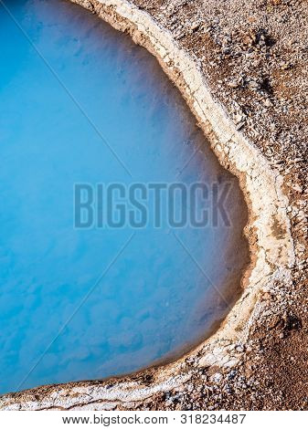 Blue Geothermal Pond At The Great Geysir, An Active Volcanic Geyser In Southwestern Iceland