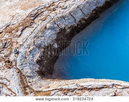 Blue Geothermal Pond At The Great Geysir, An Active Volcanic Geyser In Southwestern Iceland