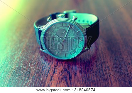 Brown Leather Watch Strap On Mens Luxury Watch Laying On Dark Rustic Wooden Table. Close Up. Copy Sp