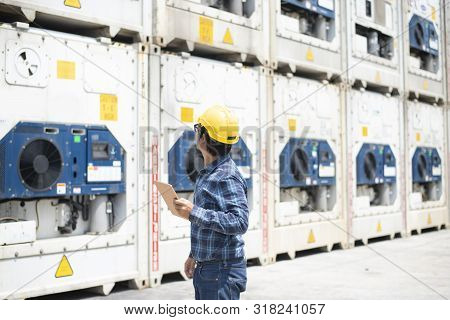 A Reefer Container Technician Is Looking And Take Care Of Frozen Or Chill Cargo With Handling Tablet