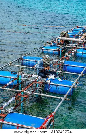 Workers Settle And Setup The Waterworks Fountain Machine On The Surface Of The Sea.