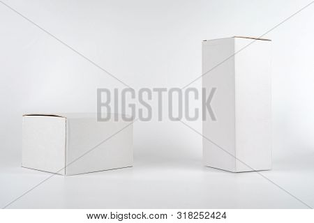 White Two Paper Boxes - Tall And Fat Lay On The White Background In Studio Shot With Clipping Paht.
