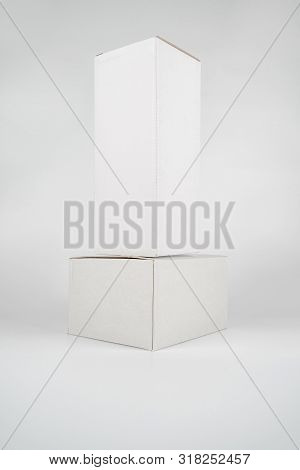 White Two Paper Boxes - Tall And Fat Lay On The White Background In Studio Shot With Clipping Paht.