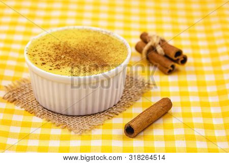 Dessert Of Curau. Brazilian Sweet Corn, Corn Mousse With Cinnamon On A Wooden Background. Typical Br