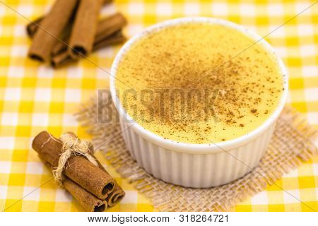 Dessert Of Curau. Brazilian Sweet Corn, Corn Mousse With Cinnamon On A Wooden Background. Typical Br