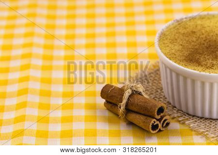 Dessert Of Curau. Brazilian Sweet Corn, Corn Mousse With Cinnamon On A Wooden Background. Typical Br