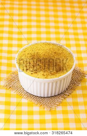 Dessert Of Curau. Brazilian Sweet Corn, Corn Mousse With Cinnamon On A Wooden Background. Typical Br