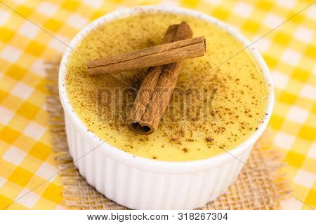 Dessert Of Curau. Brazilian Sweet Corn, Corn Mousse With Cinnamon On A Wooden Background. Typical Br